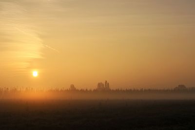 Scenic view of field against sky during sunset