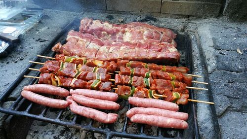 High angle view of meat on barbecue grill