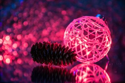 Close-up of pine cone and christmas ornament on table