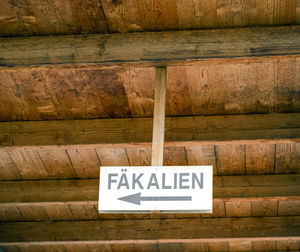 Low angle view of sign board hanging at ceiling