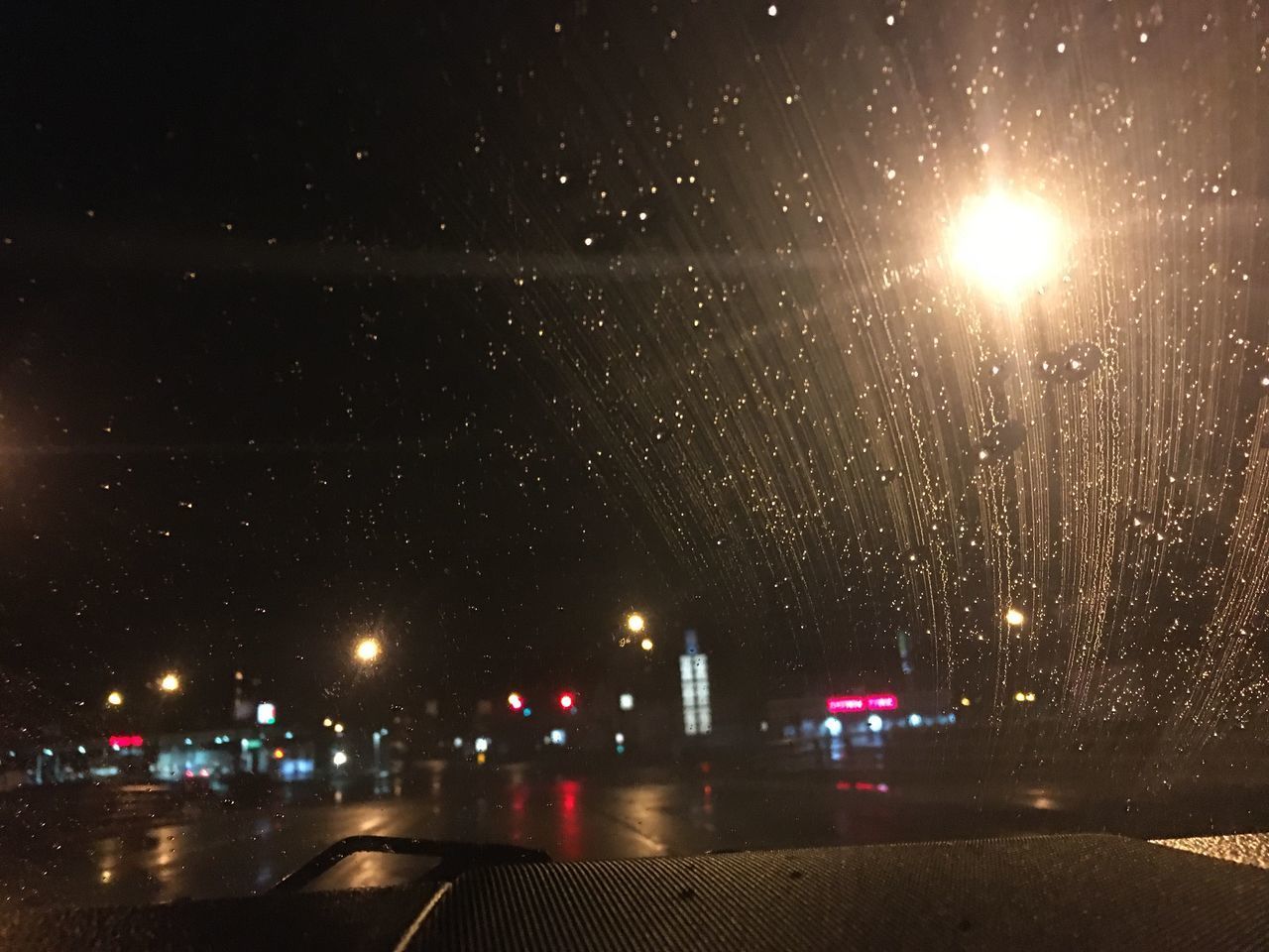 ILLUMINATED CITY STREET DURING RAINY SEASON