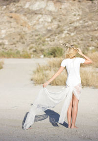 Full length of woman standing on railing