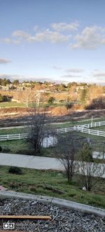 Scenic view of river amidst field against sky