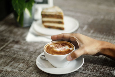 Midsection of coffee cup on table