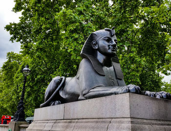 Statue against trees