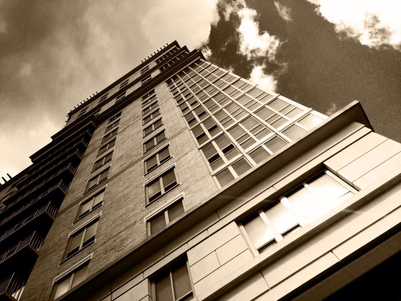 architecture, low angle view, built structure, building exterior, window, sky, building, glass - material, cloud - sky, city, modern, reflection, cloud, cloudy, day, residential building, office building, no people, balcony, outdoors