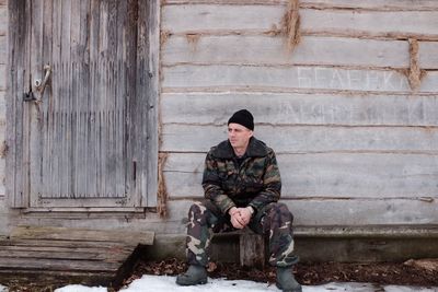 Portrait of woman sitting on wooden floor