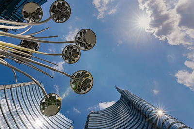 Low angle view of buildings against sky on sunny day