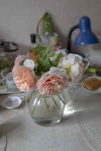 High angle view of white roses in vase on table
