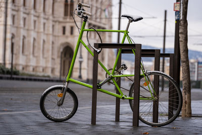 Bicycle parked on footpath by street