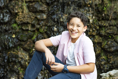 Portrait of smiling girl on rock