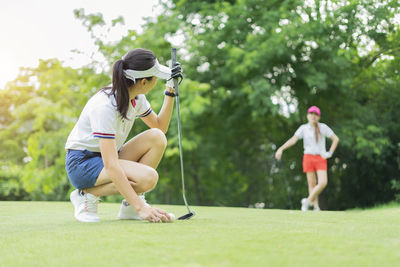 Woman standing on golf course