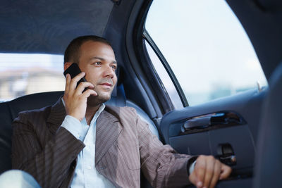 Man using mobile phone in car