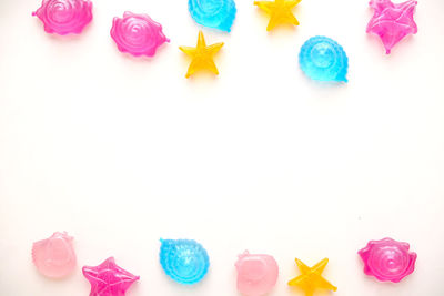 Close-up of multi colored candies against white background