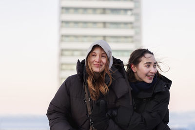 Smiling female couple in winter clothing