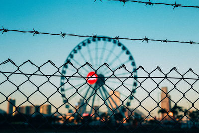 Close-up of chainlink fence against clear blue sky