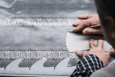 Close-up of shoemaker working on template in his workshop