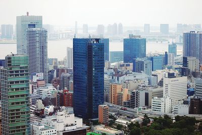 High angle view of modern buildings in city against sky