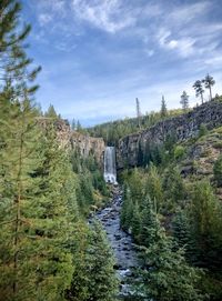 Scenic view of waterfall against sky