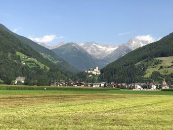 Scenic view of field and mountains against sky