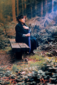 Young woman sitting on rock