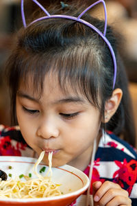 Cute girl eating food at restaurant