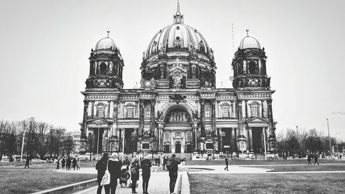 Group of people in front of building against sky