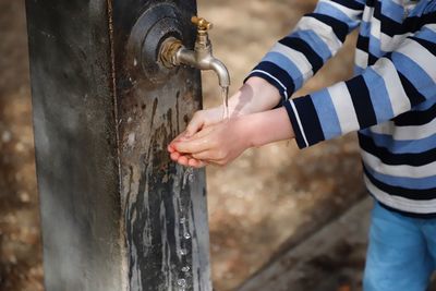 Close-up of hands holding metal