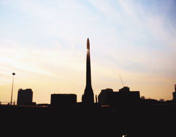 Low angle view of silhouette monument against sky