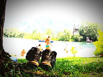 People relaxing on grassy field