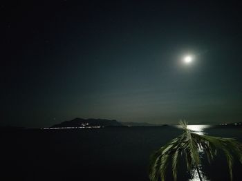 Scenic view of sea against clear sky at night