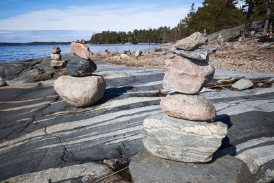 Rocks on beach against sky