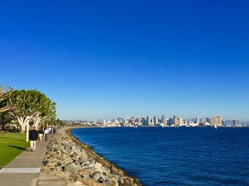 View of cityscape against clear blue sky