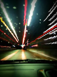 Light trails on road seen through car windshield