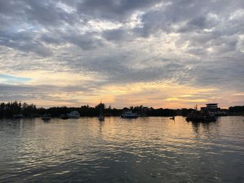 Scenic view of river against sky at sunset