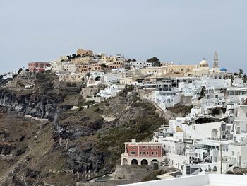 High angle view of townscape by sea against clear sky