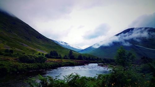 Scenic view of lake and mountains against sky