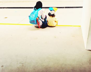 Boy playing with multi colored umbrella