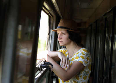 Woman looking through train window