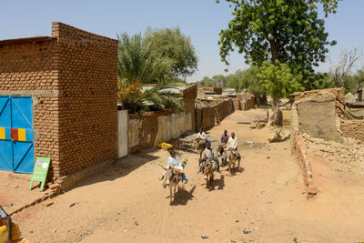 People riding bicycle on building