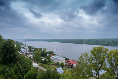 High angle view of buildings and sea against sky