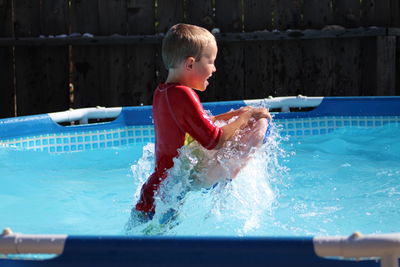 Boy playing in swimming pool