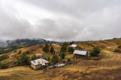 Houses on field against sky