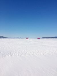 Scenic view of desert against clear blue sky