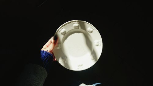 Close-up of coffee cup against black background