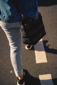 Low section of people walking on road