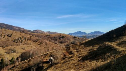 Scenic view of mountains against blue sky