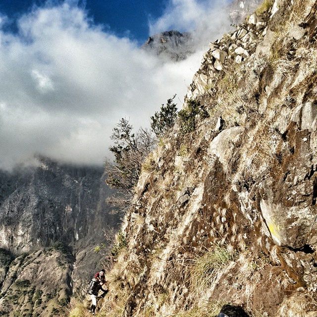 mountain, leisure activity, adventure, lifestyles, hiking, tranquility, scenics, tranquil scene, sky, beauty in nature, landscape, men, nature, mountain range, non-urban scene, rocky mountains, rock - object, cloud - sky