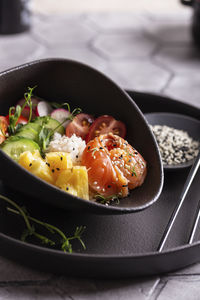 Dinner with fresh poke salad with salmon