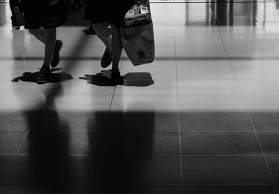 Low section of people walking at airport